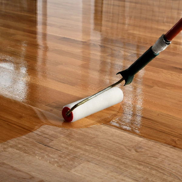 paint roller applying a clear, glossy finish